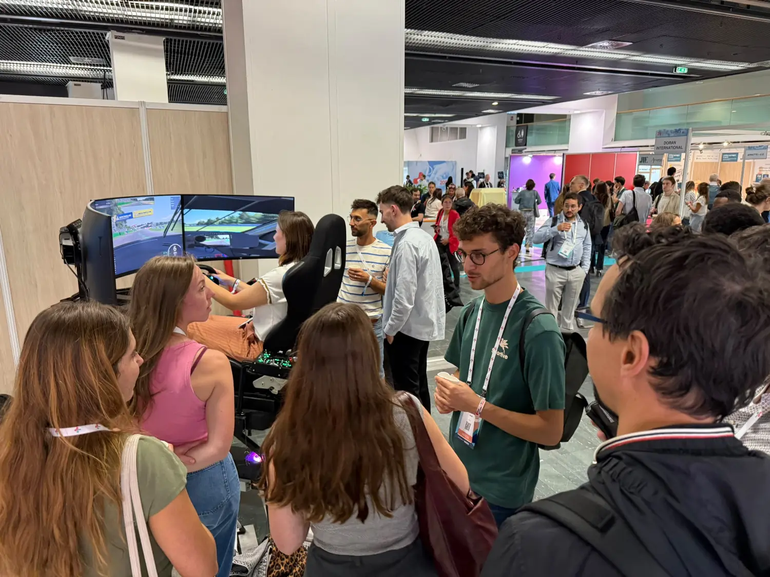 Crowd gathered around YesWeSim simulators at a trade show