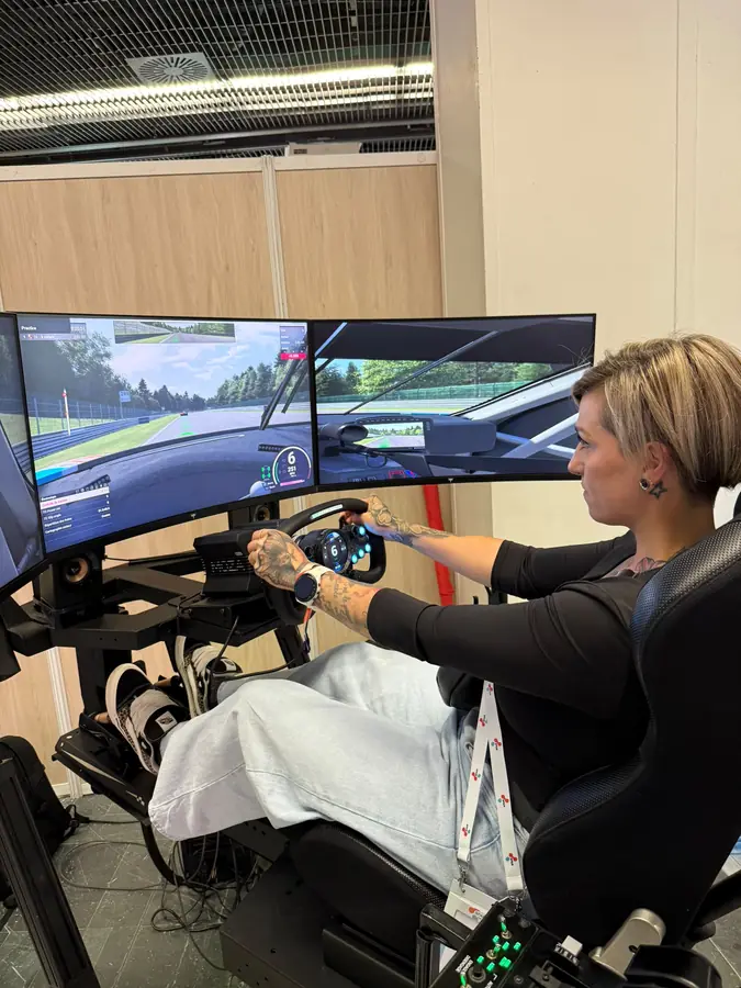 Guest racing on a motion simulator at an event